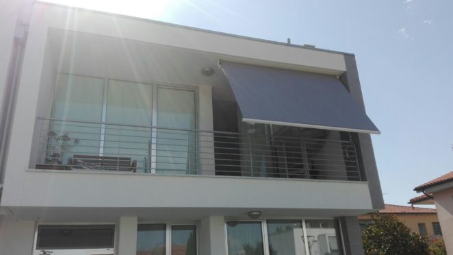 tenda a bracci a tinta unita grigia su misura per schermatura di una parte del terrazzo