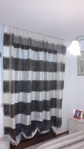 tende a finto pacchetto a righe orizzontali bianche e nere per porta finesta di camera da letto