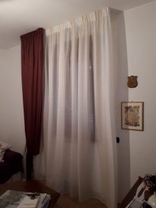 tenda arricciata su binario con calata solo da un lato composta da doppio velo e con embrasse coordinato